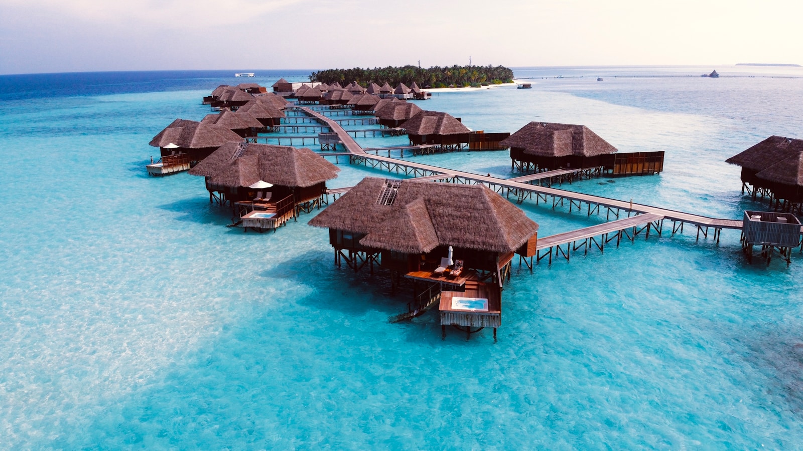Overwater thatched villas on a turquoise lagoon, Maldives
