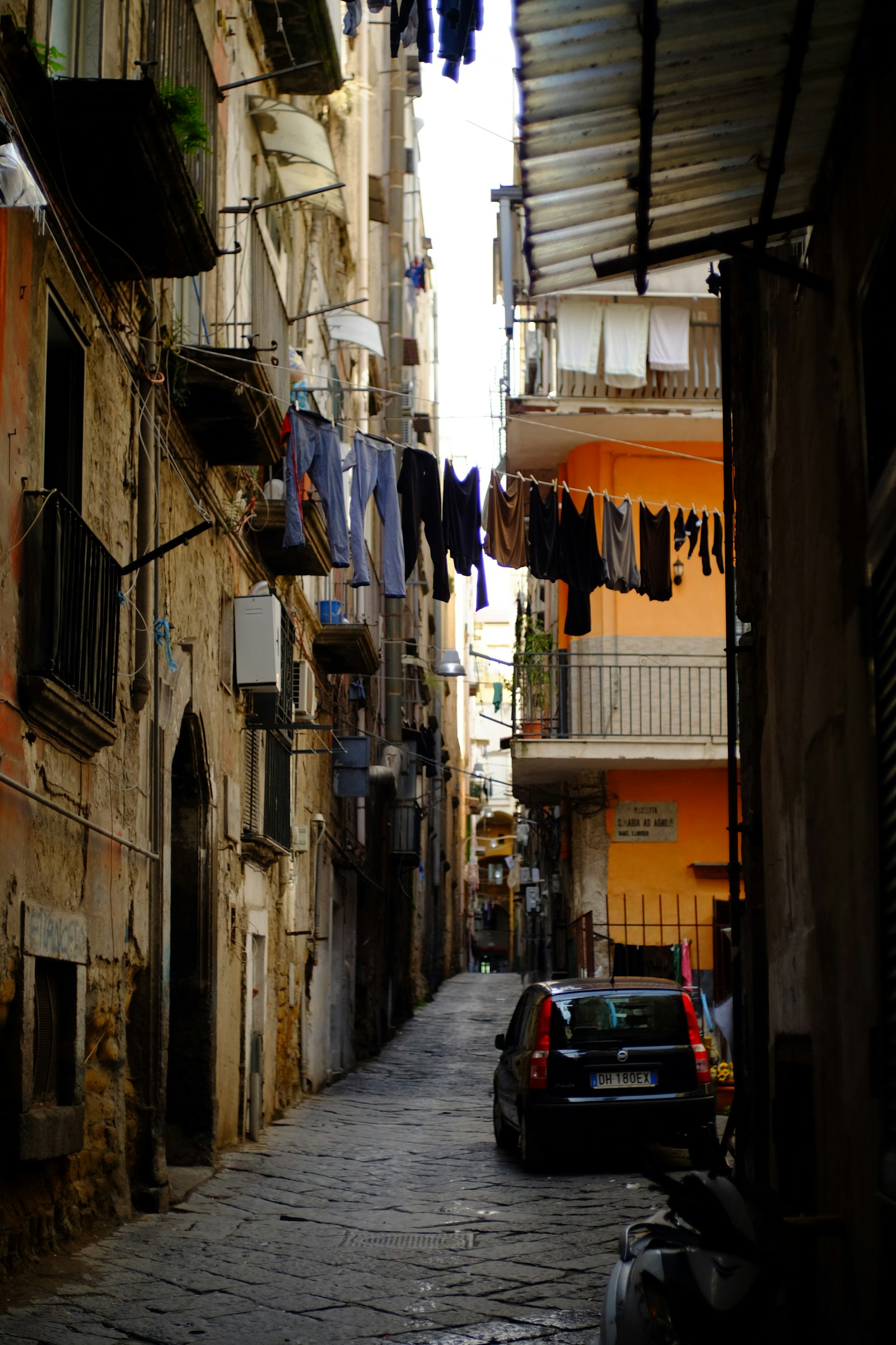 Narrow Naples old-town alley with laundry overhead