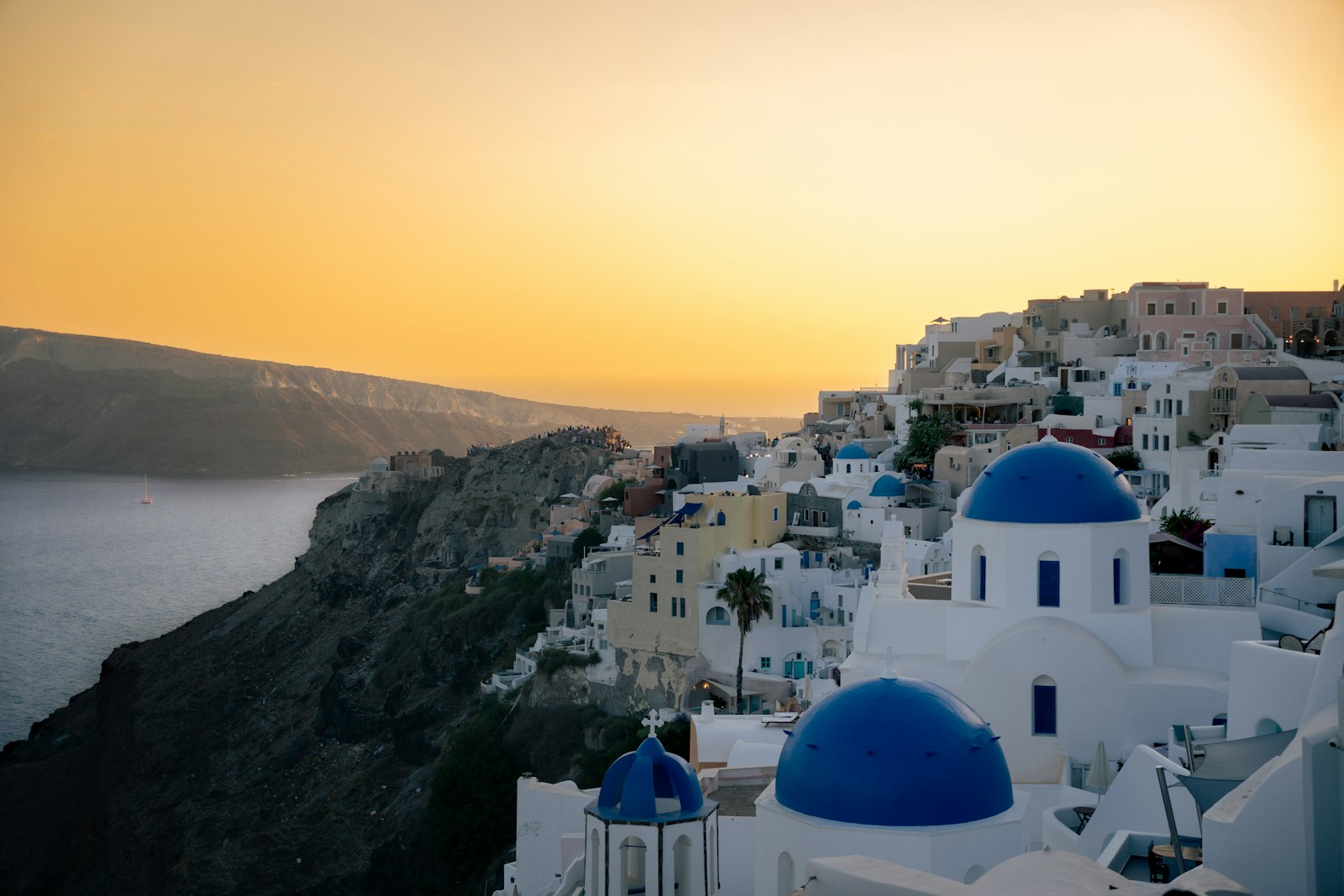 Whitewashed village with blue-domed churches at sunset, Cyclades