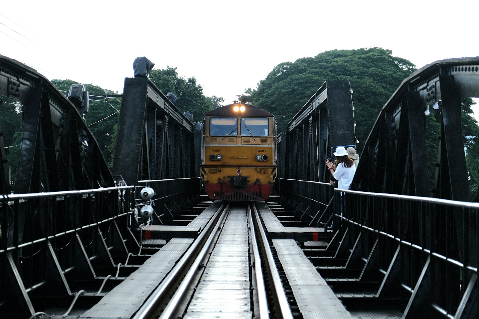 Death Railway train crossing the steel bridge at dusk, Kanchanaburi