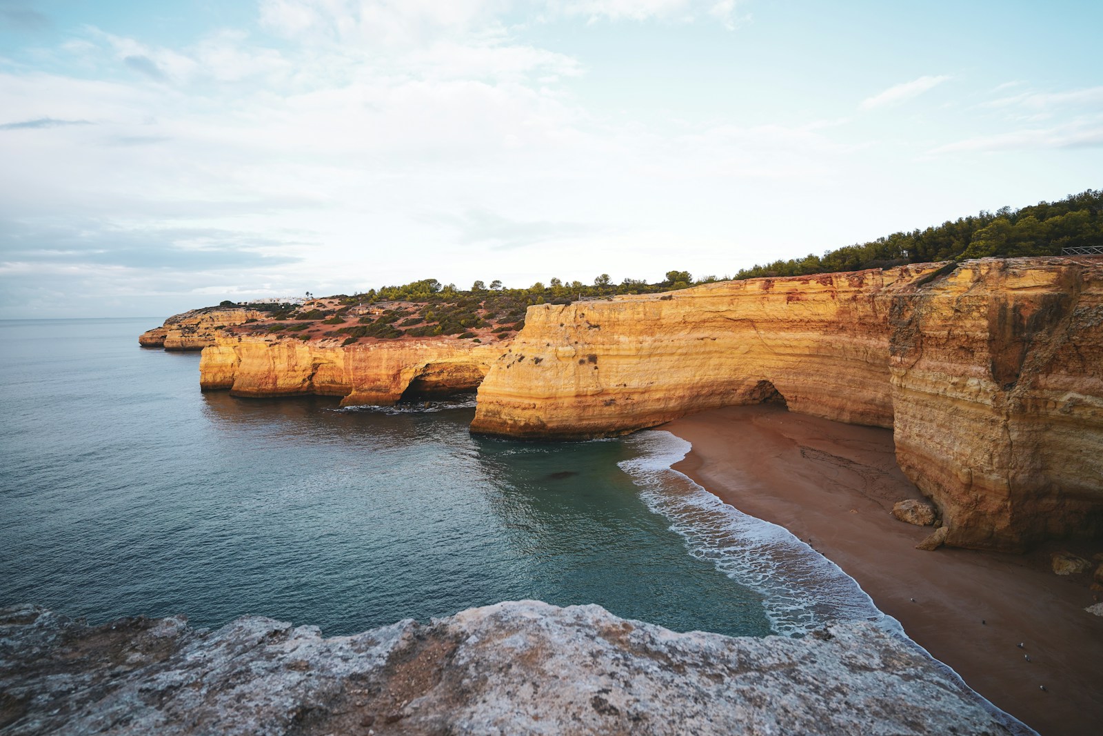 Golden Algarve sea cliffs and a quiet cove