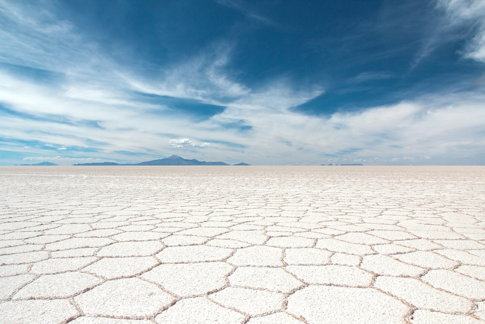 Hexagonal salt crust pattern stretching to the horizon