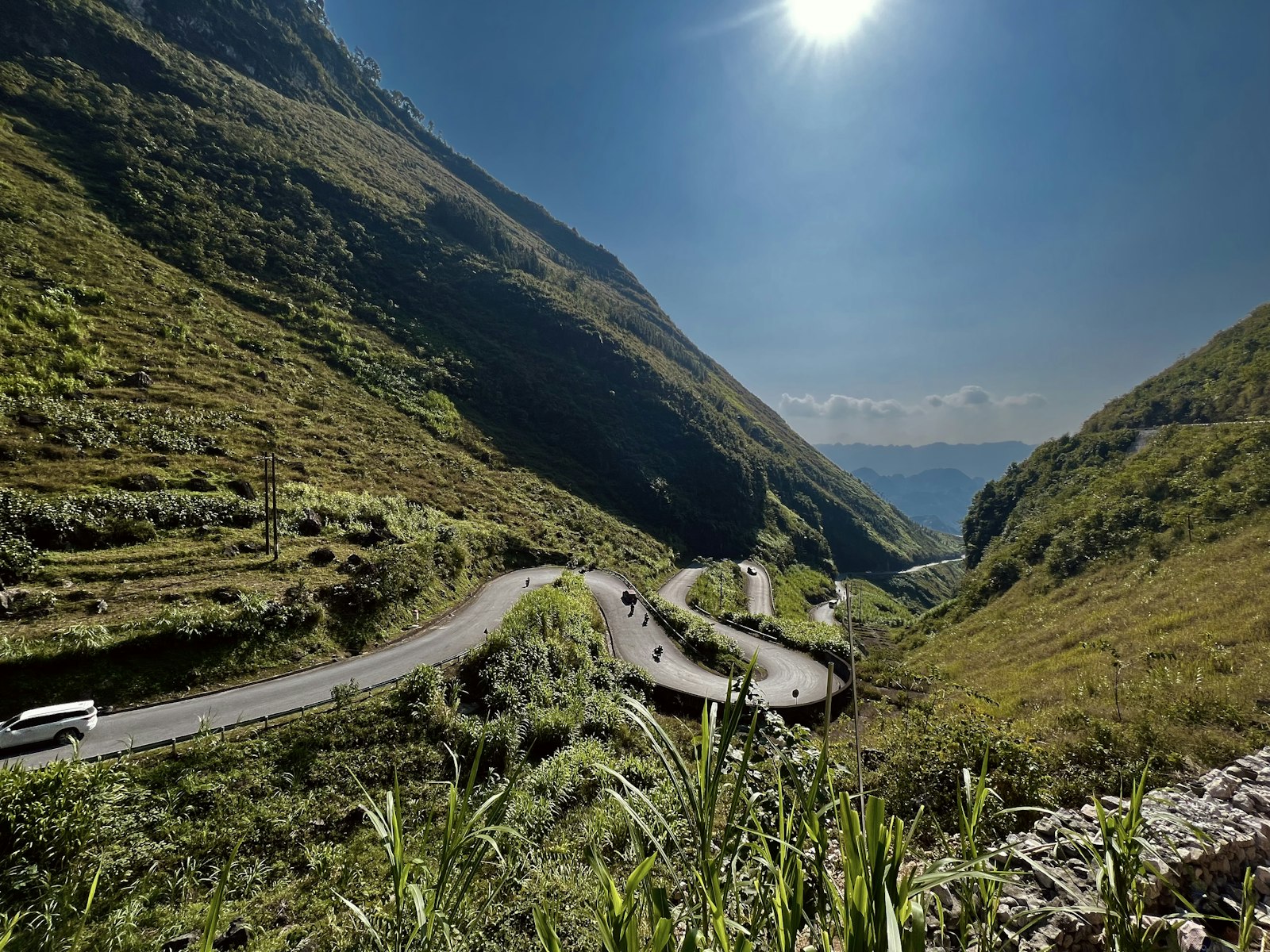 Motorbikes on a hairpin switchback above the Nho Que River valley