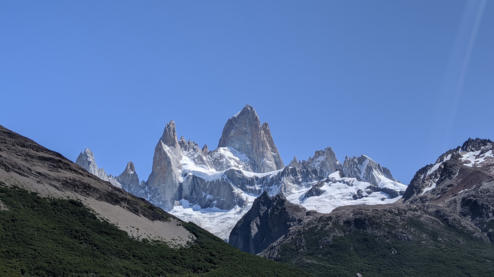 Fitz Roy peaks rising behind rugged foothills
