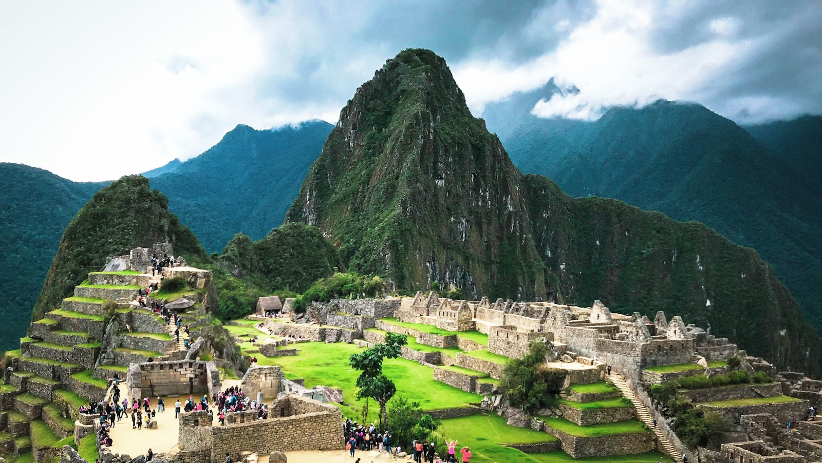 Machu Picchu terraces under cloud-wrapped peaks
